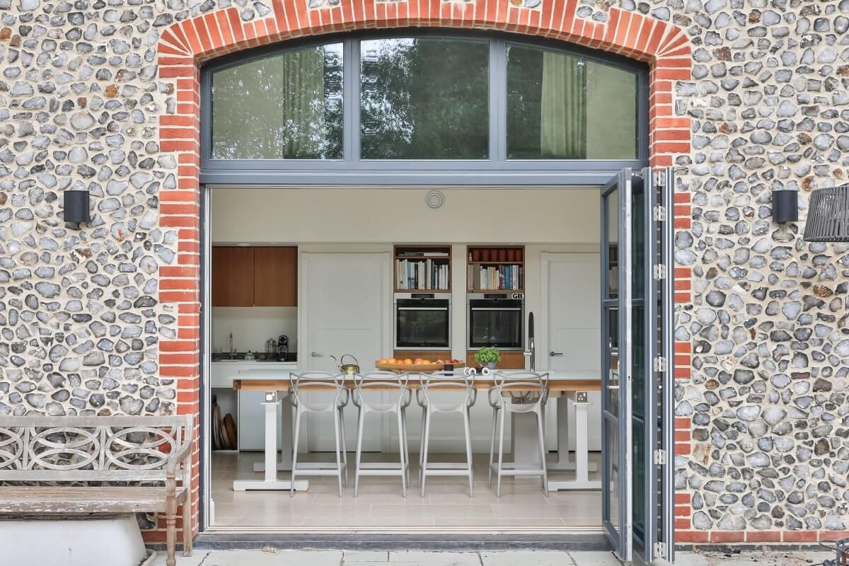 Clare Nash Architecture - eco barn build, flint and stone, looking into kitchen