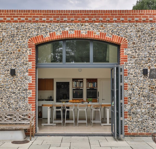 Clare Nash Architecture converted stone barn with steel grey bifold doors open