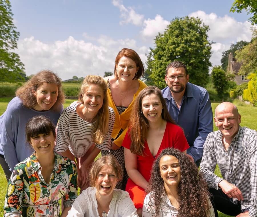 Clare Nash Architecture team in a filed on a warm sunny day