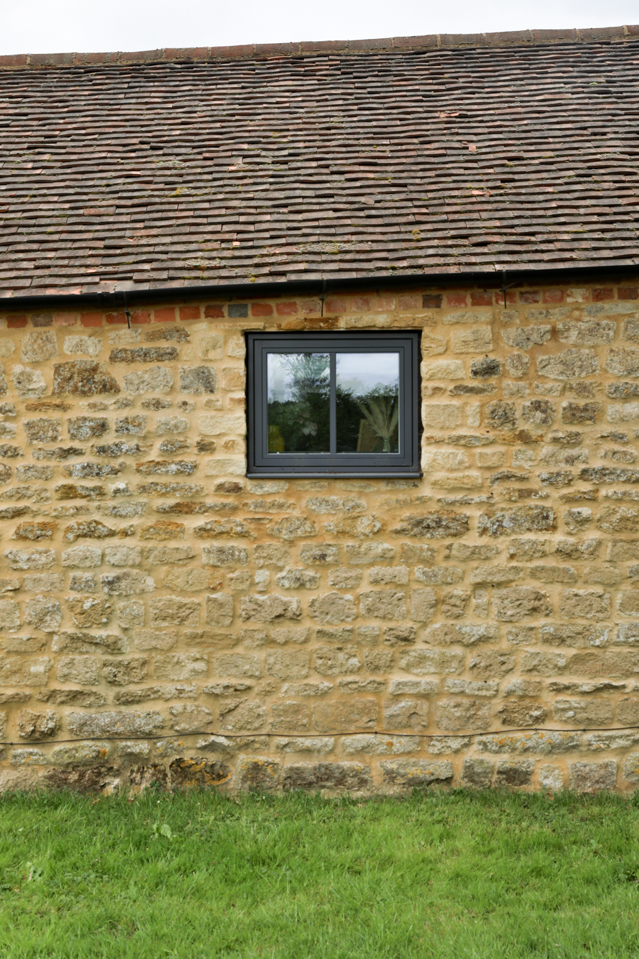 grey windows on stone barn