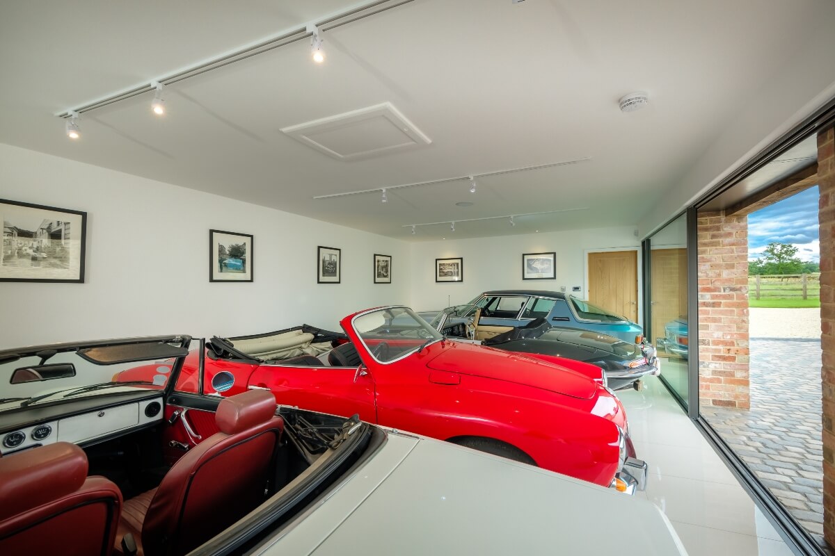 Sports cars parked inside barn conversion